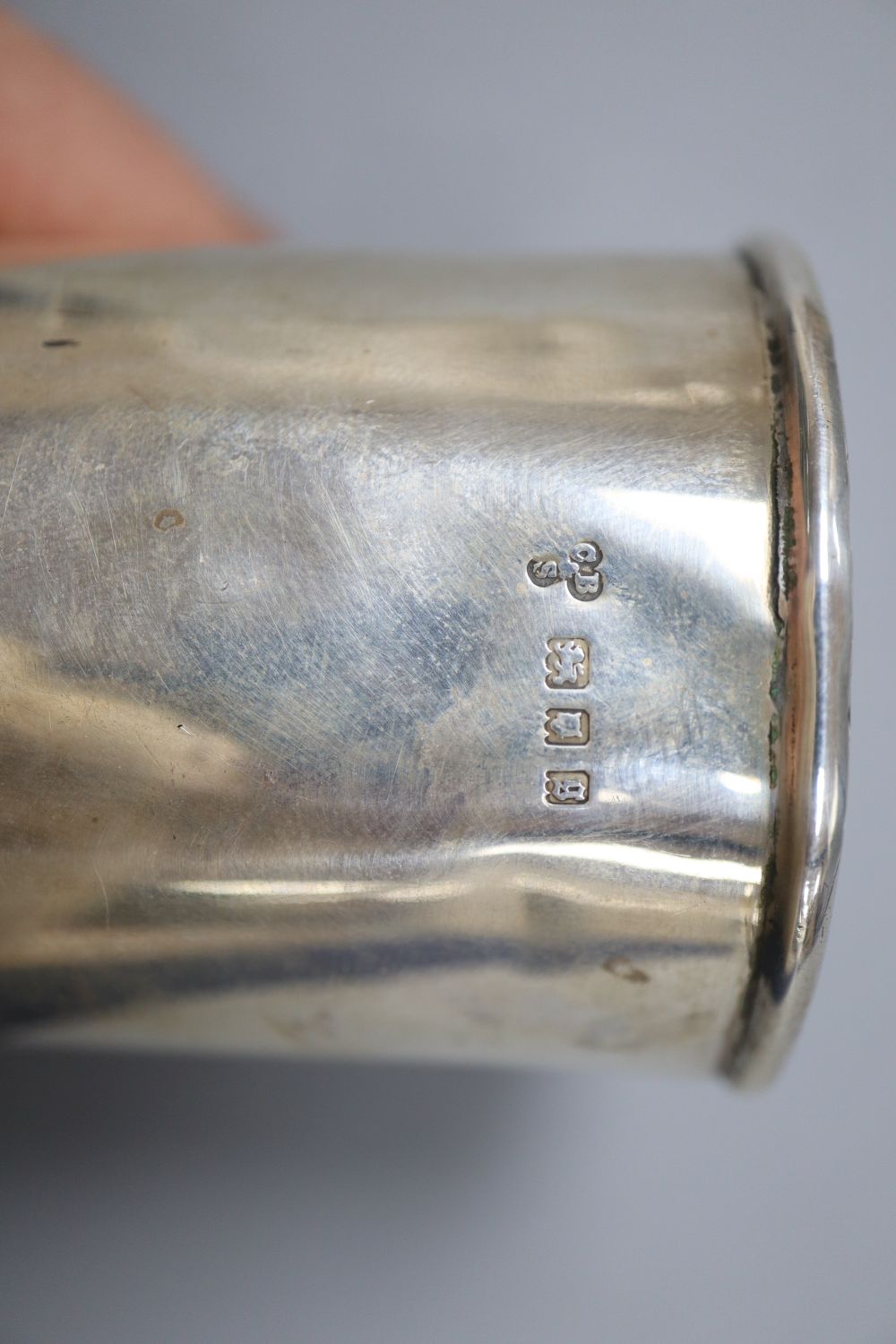 A pair of Russian (1927-1958) white metal and niello tots, a beaker, a strainer? and a spoon and pusher.